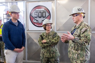 The Honorable Erik Raven, Under Secretary of the Navy, and Adm. Lisa Franchetti, Vice Chief of Naval Operations, speak to Capt. Jip Mosman, commander, Puget Sound Naval Shipyard & Intermediate Maintenance Facility, during a tour of the Machine Shop, Building 431, March 29, 2023. (U.S Navy Photo by Wendy Hallmark)