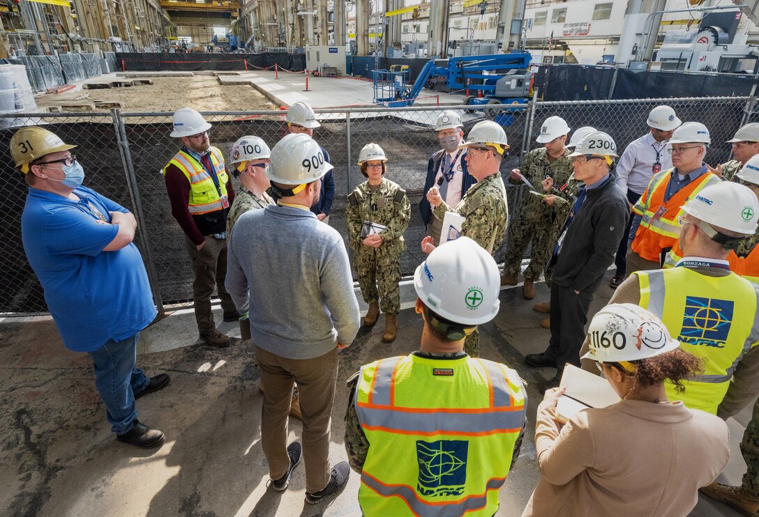 The Honorable Erik Raven, Under Secretary of the Navy; Adm. Lisa Franchetti, Vice Chief of Naval Operations; and Rear Adm. Dean VanderLey, commander, Naval Facilities Engineering Systems Command, discuss ongoing construction work in the Machine Shop, Building 431, at Puget Sound Naval Shipyard & Intermediate Maintenance Facility in Bremerton, Washington, March 29, 2023. (U.S Navy Photo by Wendy Hallmark)