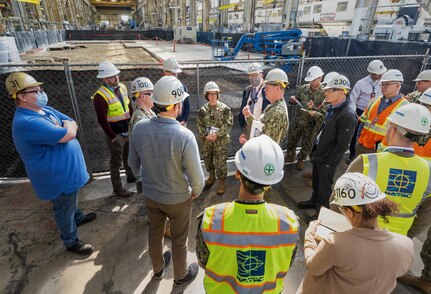 The Honorable Erik Raven, Under Secretary of the Navy; Adm. Lisa Franchetti, Vice Chief of Naval Operations; and Rear Adm. Dean VanderLey, commander, Naval Facilities Engineering Systems Command, discuss ongoing construction work in the Machine Shop, Building 431, at Puget Sound Naval Shipyard & Intermediate Maintenance Facility in Bremerton, Washington, March 29, 2023. (U.S Navy Photo by Wendy Hallmark)