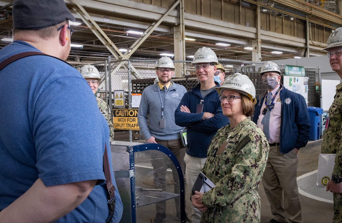 The Honorable Erik Raven, Under Secretary of the Navy, and Adm. Lisa Franchetti, Vice Chief of Naval Operations, speak to mechanics in the Machine Shop, Building 431, at Puget Sound Naval Shipyard & Intermediate Maintenance Facility in Bremerton, Washington, during a tour March 29, 2023. (U.S Navy Photo by Wendy Hallmark)