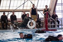 A U.S. Marine dives into the pool during basic water survival training at the Mainside Pool, Marine Corps Air Station Cherry Point, North Carolina, March 22,2023. The Marines participated in a total of five events to ensure combat readiness for surviving any waterborne accident. (U.S. Marine Corps photo by Lance Cpl. Matthew Williams)