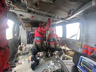 Naval Air Station Whidbey Island Search and Rescue crew members tend to an injured snowmobiler rescued April 1, 2023 near Mount Baker.