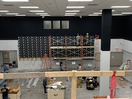 Photo of employees installing video equipment