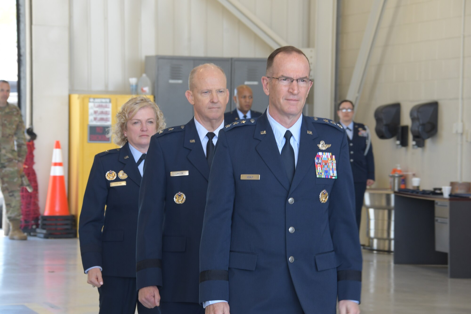Brig. Gen. Melissa A. Coburn (back) prepares to take command of 22nd Air Force from Maj. Gen. Bret C. Larson (center) during a ceremony at Dobbins Air Reserve Base, Georgia, April 2. 2023. The ceremony was officiated by Lt. Gen. John P. Healy (front) commander of Air Force Reserve and Chief of the Air Force Reserve.