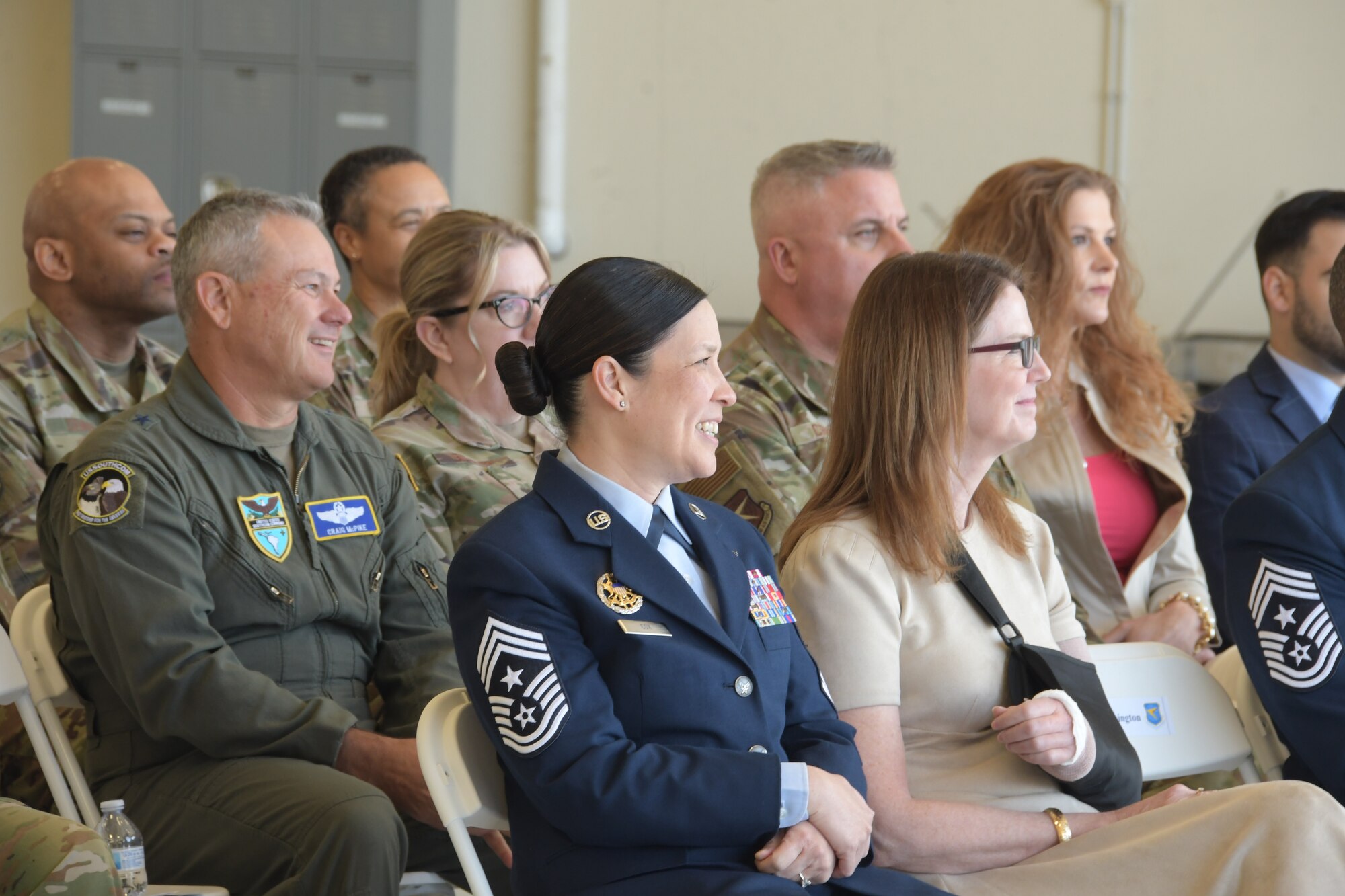 Audience members laugh during a speech from Air Force Reserve Commander and Chief of the Air Force Reserve Lt. Gen. John P Healy during the 22nd Air Force Change of Command Ceremony, held at Dobbins Air Reserve Base, Georgia, April 2, 2023.