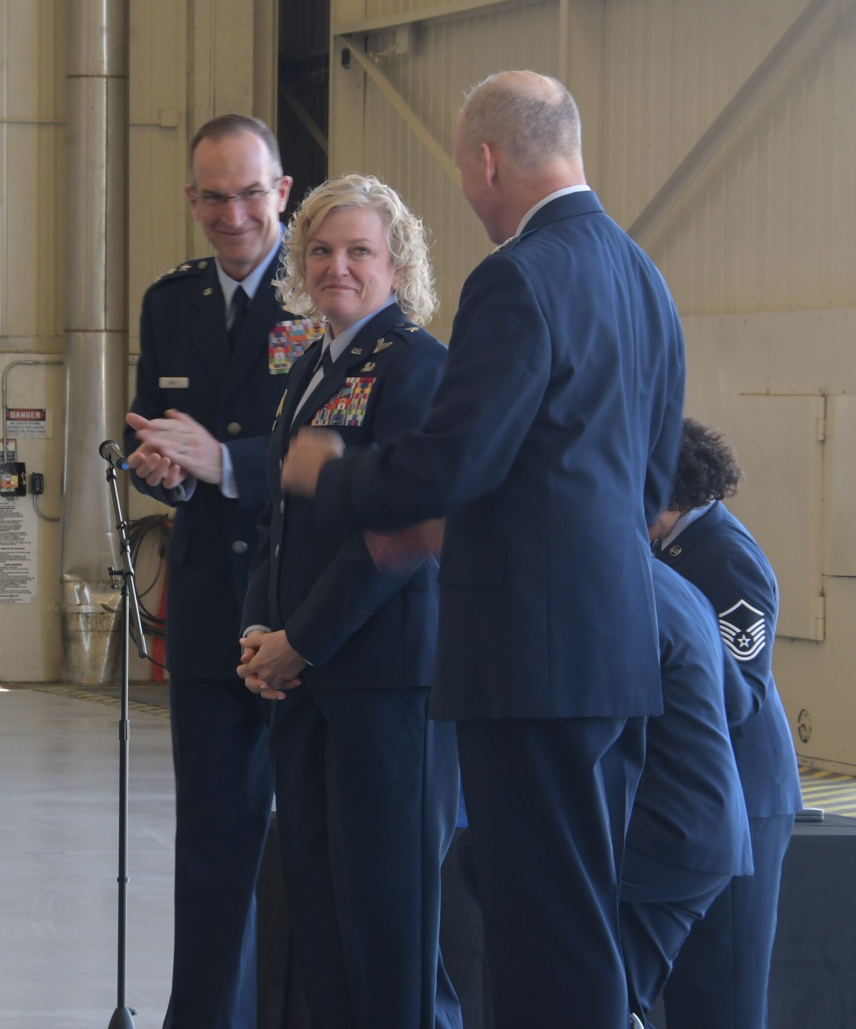 Air Force Reserve Commander and Chief of the Air Force Reserve Lt. Gen. John P. Healy and outgoing 22nd Air Force commander, Maj. Gen. Bret C. Larson applaud incoming commander Brig. Gen. Melissa A. Coburn following their change of command ceremony at Dobbins Air Reserve Base, Georgia, April 2, 2023.