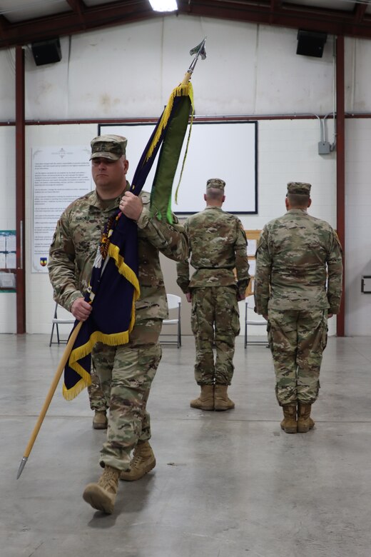 U.S. Army Sgt. Maj. Kenneth Fairchild, incoming command sergeant major, returns the regimental guidon to the guidon bearer at the 238th Regiment’s Change of Responsibility ceremony held at the Wendell H. Ford Regional Training Center, Greenville, Ky., March 25, 2023. (U.S. Army National Guard photo by Lt. Col. Carla Raisler)