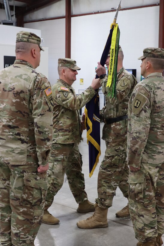 U.S. Army Col. L. Allen Joiner, outgoing commander of the 238th Regiment passes the regimental guidon to Brig. Gen Brian Wertzler, Kentucky National Guard deputy adjutant general, symbolizing the relinquishing of his command of the unit at the 238th Regiment’s Change of Command ceremony held at the Wendell H. Ford Regional Training Center, Greenville, Ky., March 25, 2023. (U.S. Army National Guard by Lt. Col. Carla Raisler)