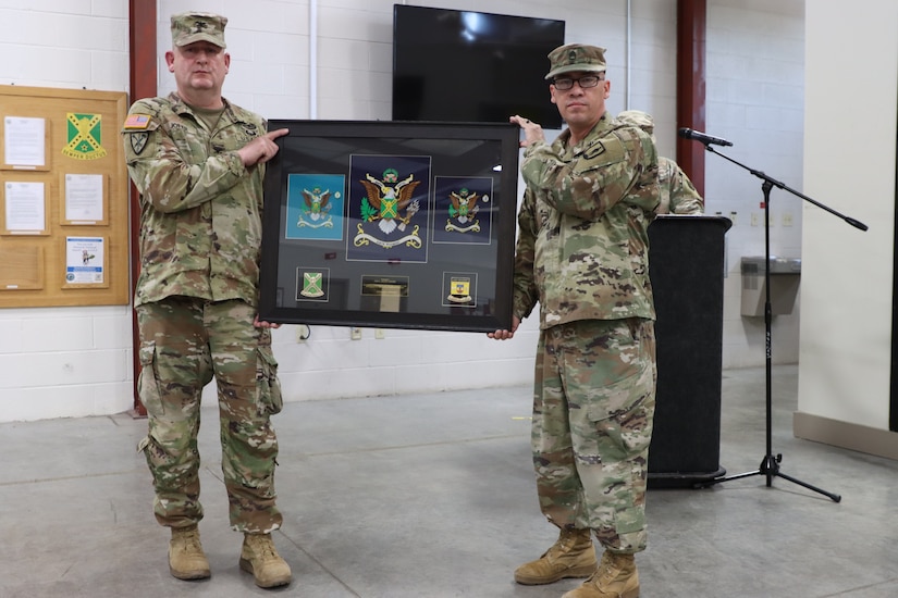 U.S. Army Col. Allen Joiner, outgoing commander of the 238th Regiment was presented with the regimental guidons by Sgt. 1st Class Rey Hernandez at the 238th Regiment’s Change of Command ceremony held at the Wendell H. Ford Regional Training Center, Greenville, Ky., March 25, 2023. (U.S. Army National Guard by Lt. Col. Carla Raisler)