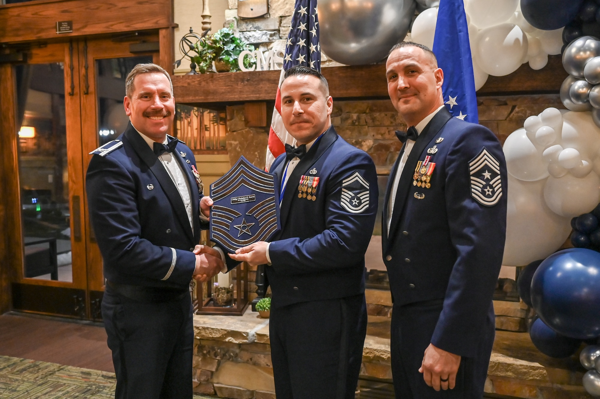 Chief Master Sgt. Christian Suarez (center), 421st Fighter Generation Squadron, poses with Col. Craig Andrle (left), 388th Fighter Wing commander, and Chief Master Sgt. Brandon Wolfgang, 388th Fighter Wing command chief.
