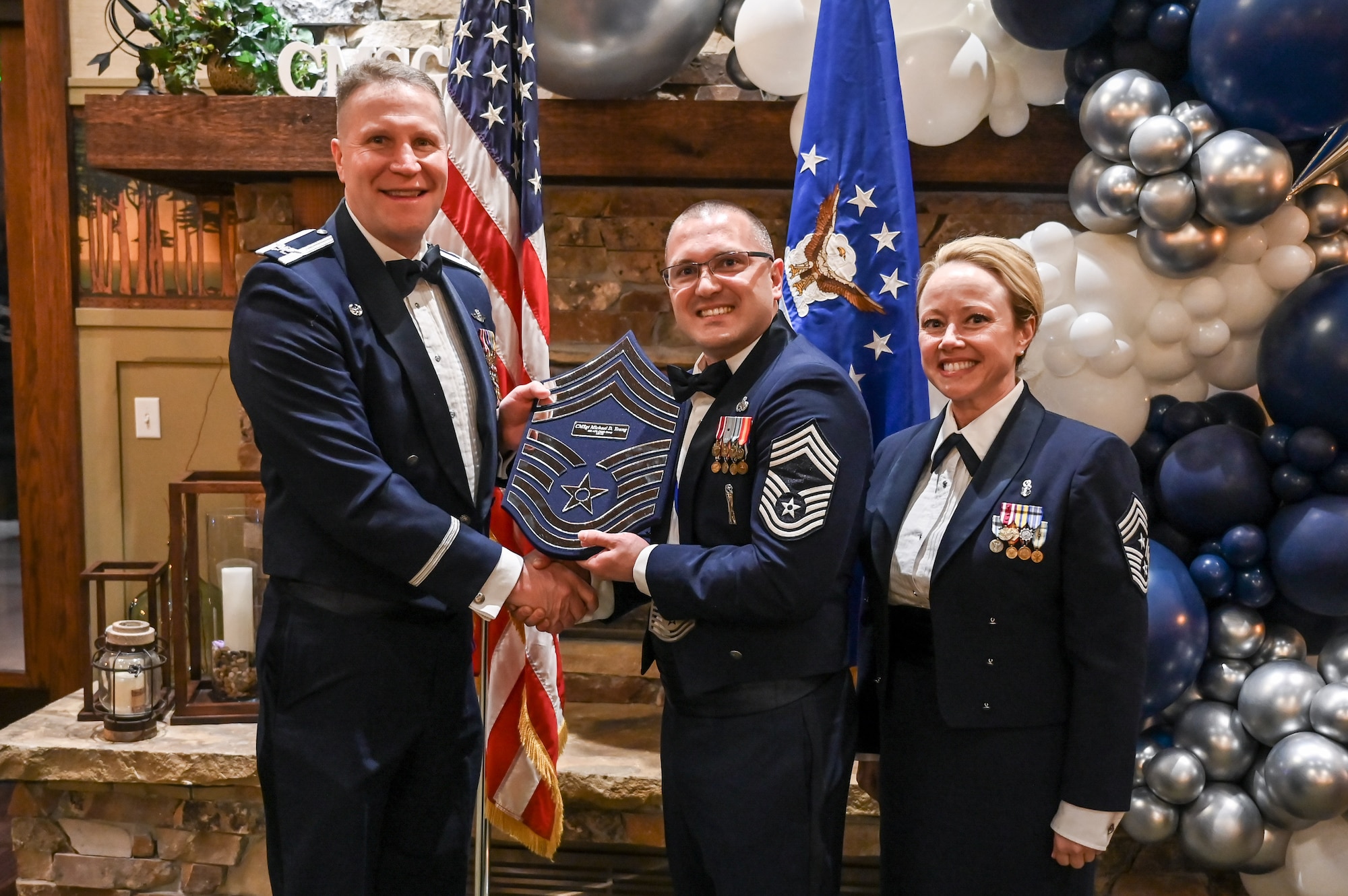 Chief Master Sgt. Michael Young (center), 419th Maintenance Group, poses with Col. Matthew Fritz (left), 419th Fighter Wing commander, and Chief Master Sgt. Heather Richins, 419th Fighter Wing command chief