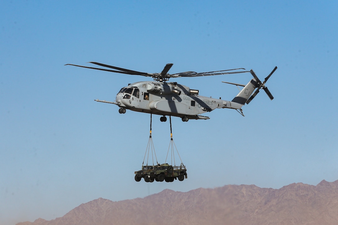U.S. Marine Corps CH-53K King Stallion helicopter assigned to Marine Heavy Helicopter Squadron (HMH) 461, 2nd Marine Aircraft Wing, executes an external lift of two High Mobility Multipurpose Wheeled Vehicle during Weapons and Tactics Instructor (WTI) course 2-23 at Auxiliary Airfield II near Yuma, Arizona, March 28, 2023. WTI is a seven-week training event hosted by MAWTS-1, providing standardized advanced tactical training and readiness, and assists in developing and employing aviation weapons and tactics. (U.S. Marine Corps photo by Lance Cpl. Ricardo Ramirez)