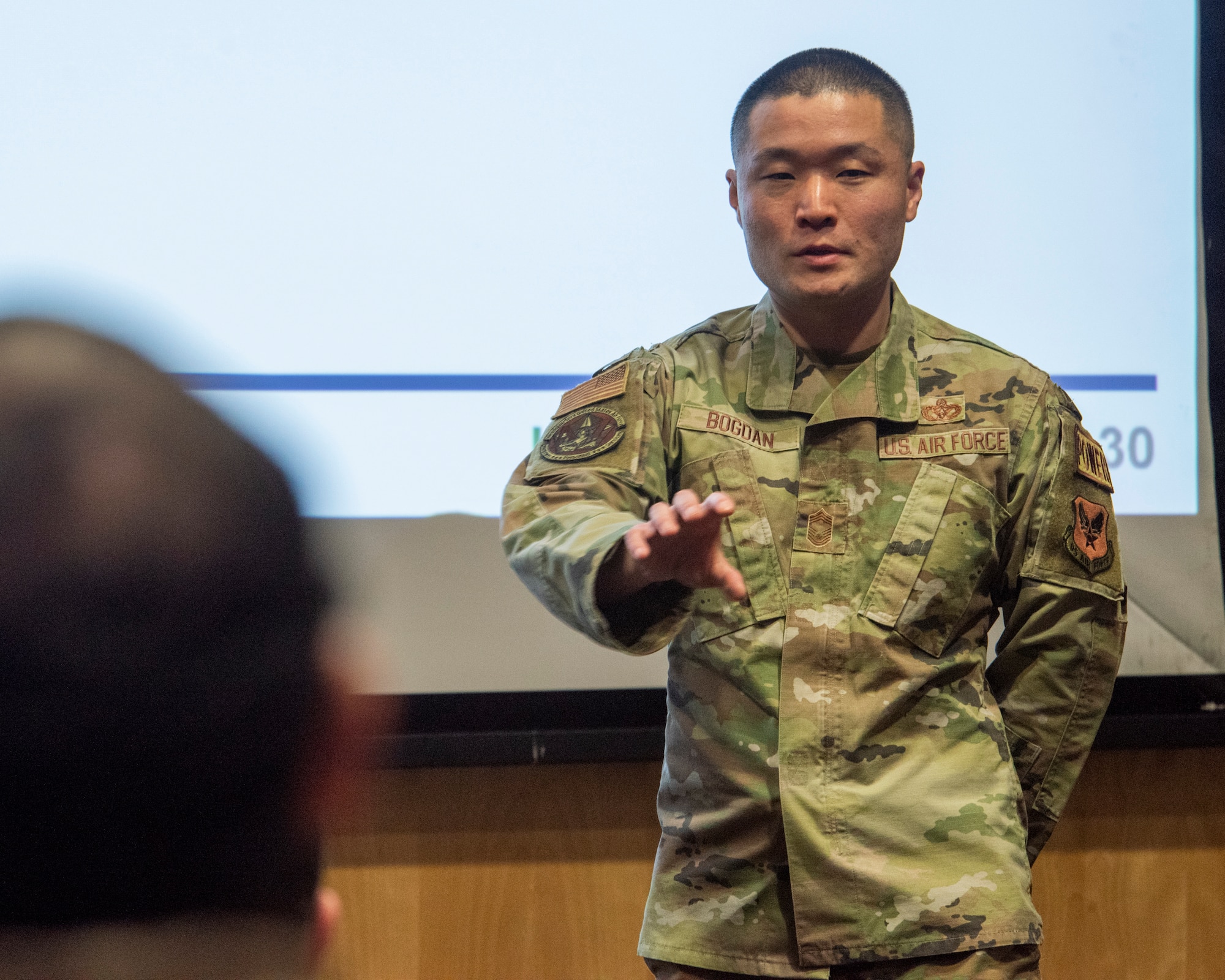 U.S. Air Force Chief Master Sgt. Joe Bogdan, Chief of Headquarters Air Force Enlisted Force Development, briefs Airmen and officers during an enlisted force development panel at Joint Base Elmendorf-Richardson, Alaska, March 30, 2023.