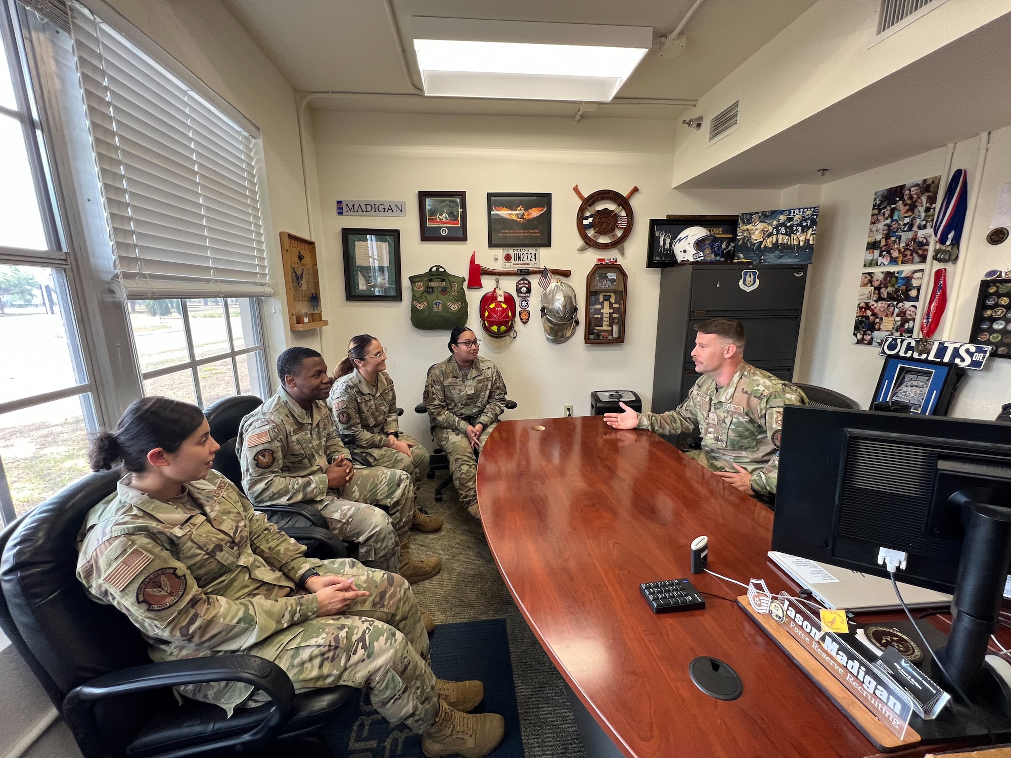 A recruiter talks with active duty Airmen about transitioning the the Reserve.