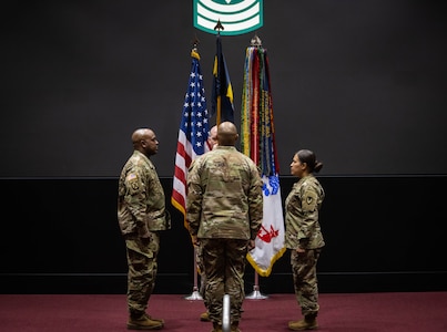 Three Soldiers on stage during a ceremony.