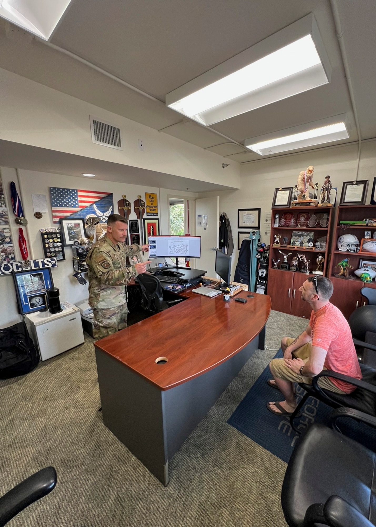 A recruiter talks to an active duty Airman prior to separating from the active duty component.