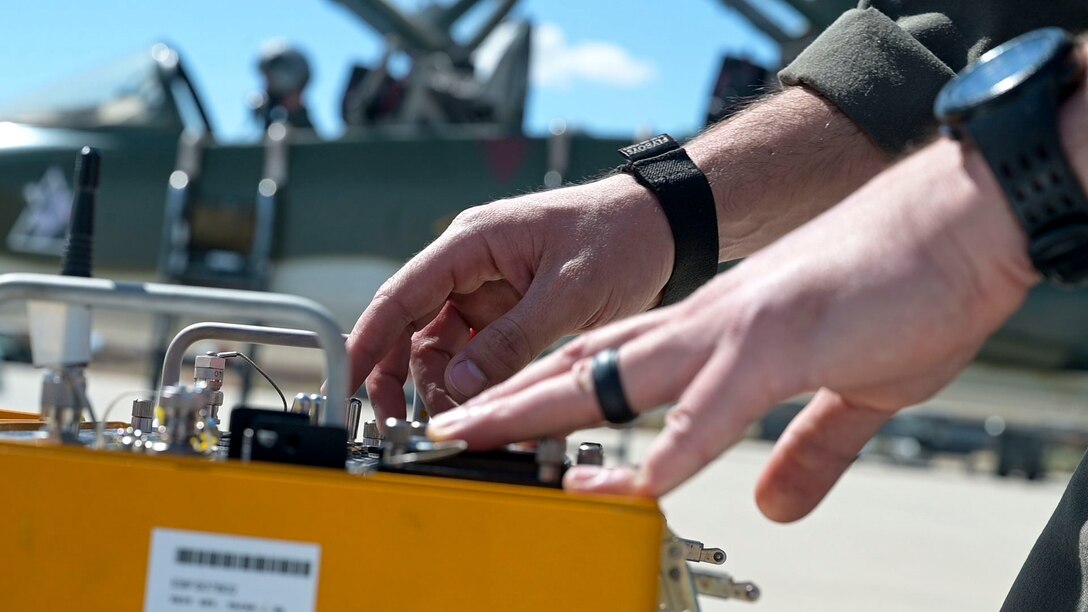 Capt. Steve "Nike" O'Briant, Project Pilot uses a test kit to test the "5tarboy" GPS system on the T-38C.