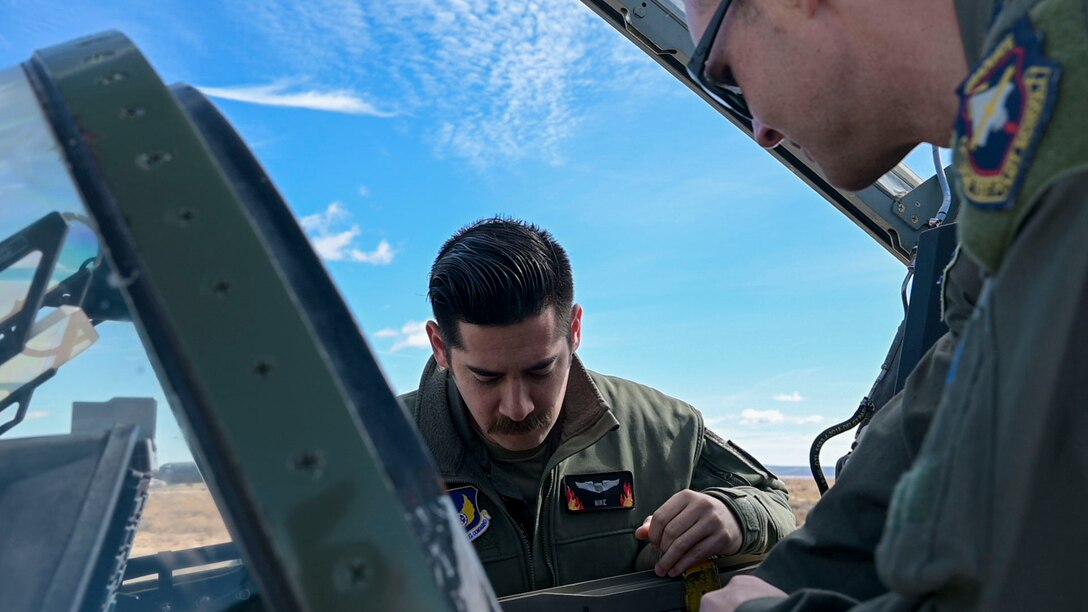 Capt. Steve "Nike" O'Briant, Project Pilot gets a lesson about the new GPS system "5tarboy". "5tarboy" would more utilize the GPS L5 signal reception through a TACAN antenna that would be more accurate for navigation guidance.