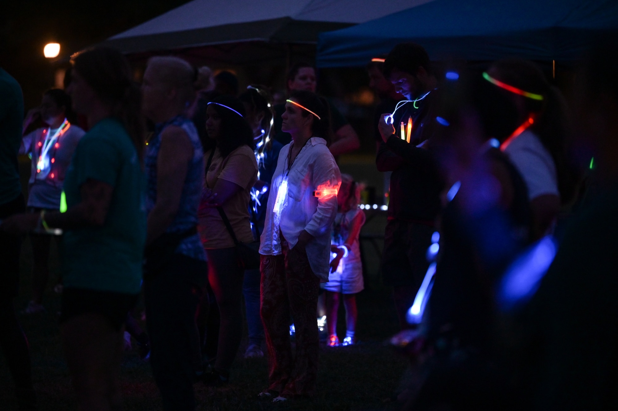 Participants listen to a Sexual Assault Awareness Prevention Month proclamation during a SAAPM glow run at the Missing Man Trail on Joint Base Pearl Harbor-Hickam, Hawaii, Mar. 31, 2023. April is designated as SAAPM, and this year the Department of Defense’s theme is “Step Forward”, encouraging individuals to use their personal strength to advance positive change in preventing sexual violence. (U.S. Air Force photo by Staff Sgt. Alan Ricker)