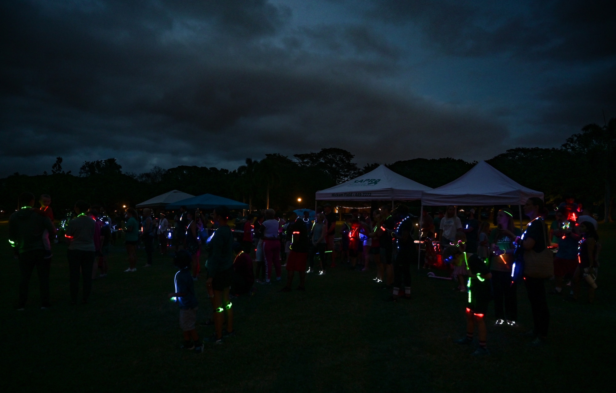 Service members and their families attend a Sexual Assault Awareness Prevention Month glow run at the Missing Man Trail on Joint Base Pearl Harbor-Hickam, Hawaii, Mar. 31, 2023. April is designated as SAAPM, and this year the Department of Defense’s theme is “Step Forward”, encouraging individuals to use their personal strength to advance positive change in preventing sexual violence. (U.S. Air Force photo by Staff Sgt. Alan Ricker)