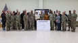 Maj. Gen. Michel M. Russell Sr., commanding general of the 1st Theater Sustainment Command, and Command Sgt. Maj. Albert E. Richardson Jr., command sergeant major of the 1st TSC, joins Soldiers attending the LeadHERship forum for a group photo at Camp Arifjan, Kuwait, March 30, 2023.