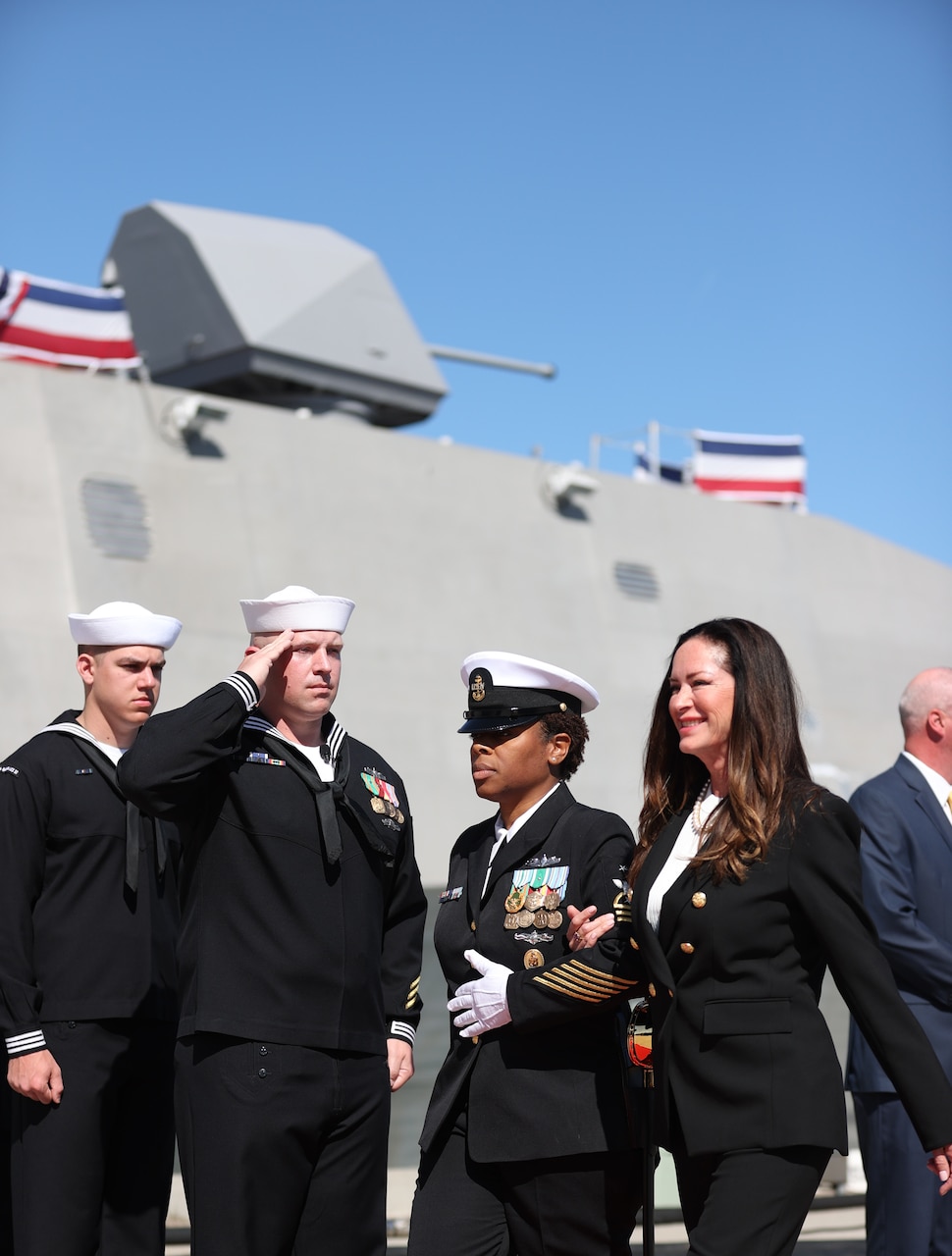 PORT HUENEME, Calif. (Apr 1, 2023) Command Senior Chief Rose Thibodeaux, Independence-class variant littoral combat ship USS Santa Barbara (LCS32), right, escorts the Ship's Sponsor, Lola Zinke during the LCS32 Commissioning Ceremony onboard Naval Base Ventura County (NBVC), Port Hueneme, Apr. 1, 2023. Littoral Combat Ships are fast, optimally-manned, mission-tailored surface combatants that operate in near-shore and open-ocean environments, winning against 21st-century coastal threats. LCS integrate with joint, combined, manned and unmanned teams to support forward presence, maritime security, sea control, and deterrence missions around the globe. NBVC is a strategically located Naval installation composed of three operating facilities: Point Mugu, Port Hueneme and San Nicolas Island. NBVC is the home of the Pacific Seabees, West Coast E-2D Hawkeyes, 3 warfare centers and 80 tenants. (U.S. Navy photo by Mass Communication 1st Class Douglas "Evan" Parker/Released)