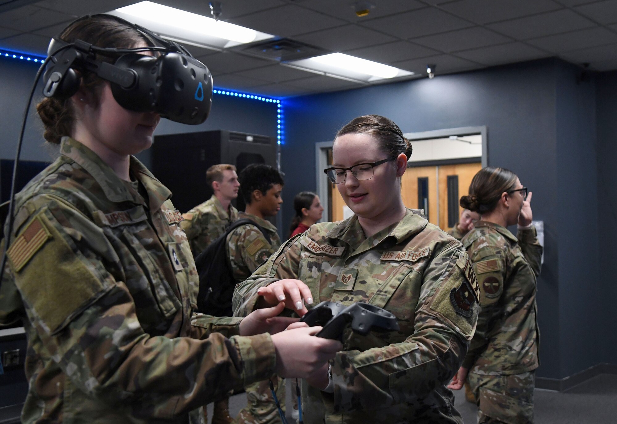 U.S. Air Force Staff Sgt. Brystal Eminhizer, 335th Training Squadron instructor, assists Kayla Simpson, Troy University Air Force ROTC cadet, with a weather virtual reality demonstration during Pathways to Blue inside the Weather Complex at Keesler Air Force Base, Mississippi, April 1, 2023.