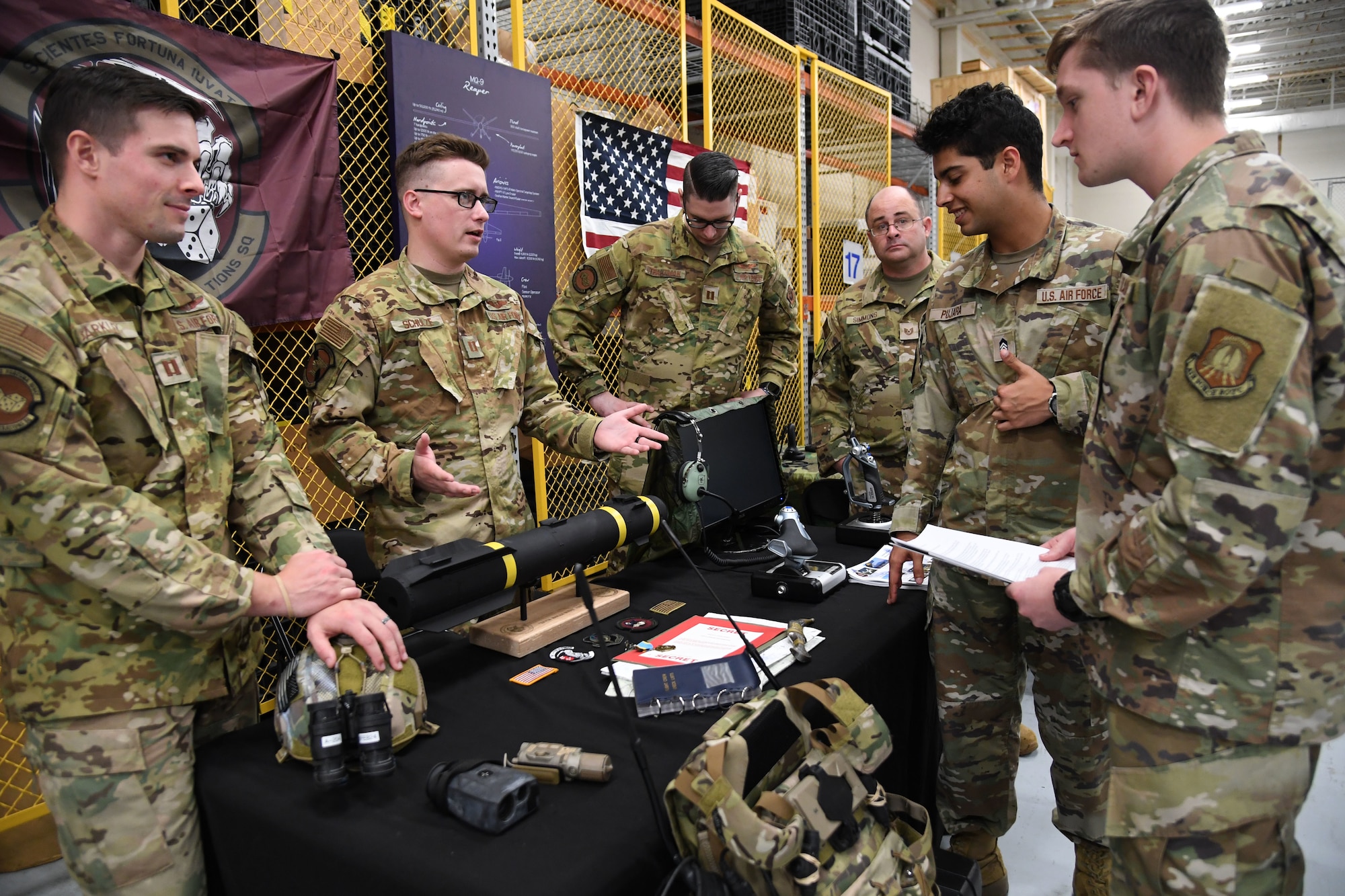 Airmen discuss remotely piloted aircraft mission capabilities to Air Force ROTC cadets during Pathways to Blue inside the Roberts Consolidated Aircraft Maintenance Facility at Keesler Air Force Base, Mississippi, March 31, 2023.