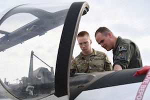 U.S. Air Force 1st Lt. Thomas Hood, 33rd Flying Training Squadron T-6 Texan instructor pilot, Vance Air Force Base, Oklahoma, shows the inside of a T-6 Texan cockpit to Samuel Martin, Texas A&M University Air Force ROTC cadet, during Pathways to Blue at Keesler Air Force Base, Mississippi, March 31, 2023.