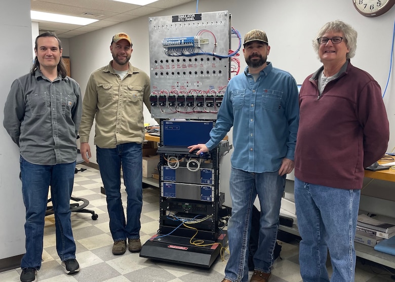 The Electronics Services Section built and coded the Supervisory Control and Data Acquisition system, which is currently being put in Nashville District hydropower plants and Detroit District hydropower plant. The control system will allow Corps engineers to operate hydropower plants from within the Nashville District. Electrical Engineer Skylar Holloway, Senior Electronics Mechanic Allen Hay, Hydropower Plant Senior Electronics Engineer Luke Ditto, and ESS Supervisor Richard Reiger show the Remote Terminal Unit simulator the team built and used to conduct testing before making and coding the system currently being installed at the Corps hydropower plants.