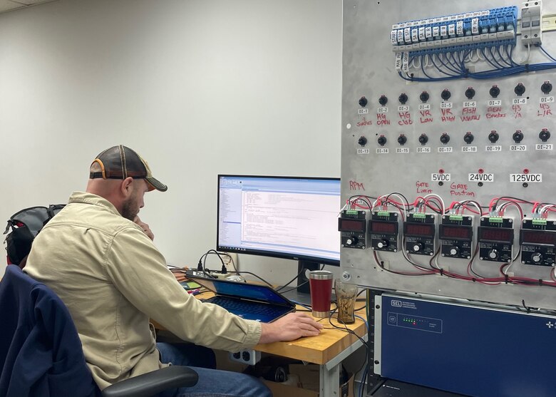Electronics Services Section Senior Electronics Mechanic Allen Hay looks over the start and stop coding for the Supervisory Control and Data Acquisition system installed at Corps of Engineers hydropower plants.