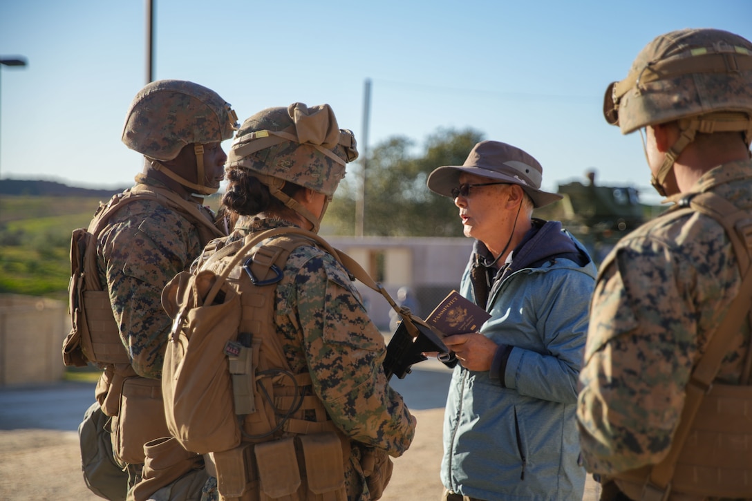 U.S. Marines assigned to Combat Logistics Battalion 15, Combat Logistics Regiment 17, 1st Marine Logistics Group, speak to a simulated evacuee during evacuation control center training as a part of CLB-15’s Marine Corps Combat Readiness Evaluation (MCCRE) at Marine Corps Base Camp Pendleton, California, Jan. 26, 2023.
