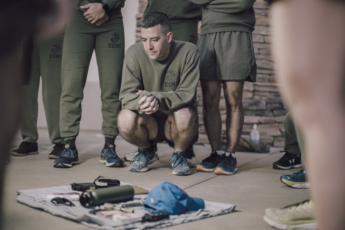 U.S. Marine Corps Maj. Peter Bose, the future operations officer assigned to the 15th Marine Expeditionary Unit, memorizes items on a tarp prior to conducting high-intensity interval training during an officer physical training session at Marine Corps Base Camp Pendleton, California, Jan. 20, 2023.