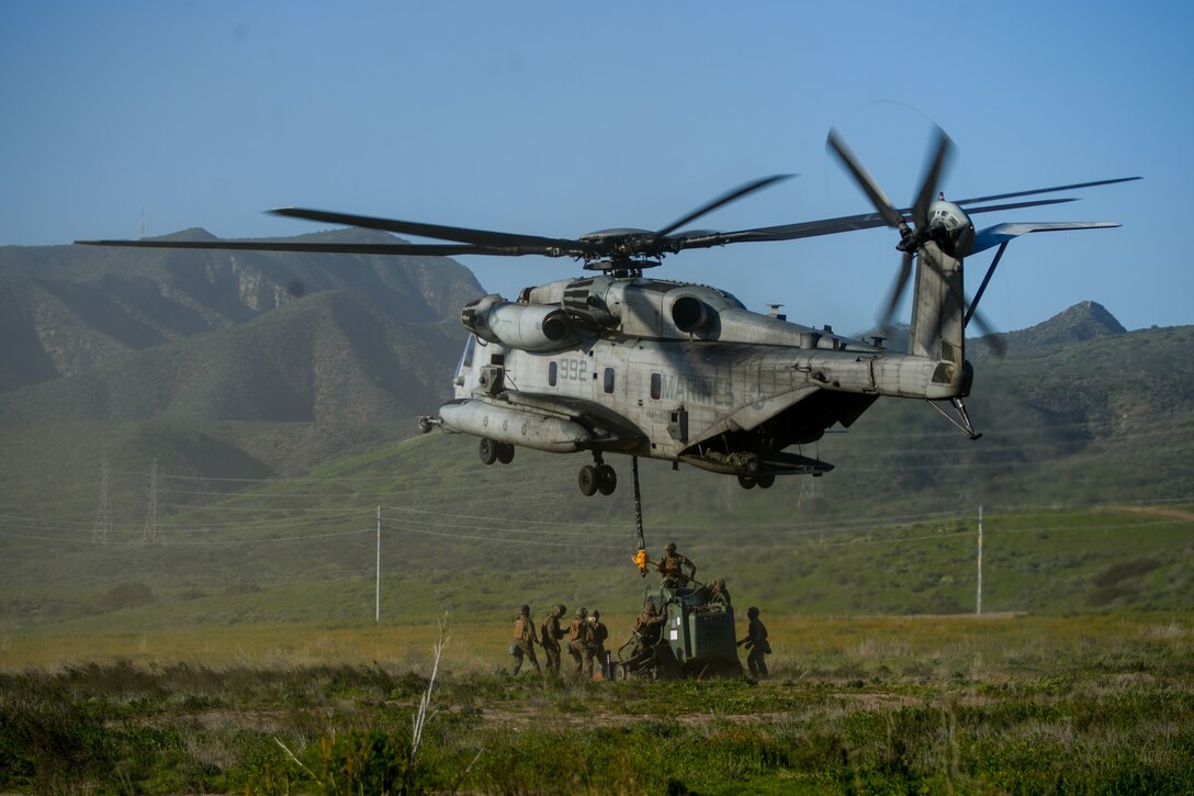 U.S. Marines assigned to Combat Logistics Battalion 15, Combat Logistics Regiment 17, 1st Marine Logistics Group, sling load a tractor rubber-tired articulated steering multi-purpose (TRAM) beneath a CH-53E Super Stallion attached to Marine Heavy Helicopter Squadron (HMH) 361, Marine Aircraft Group 16, 3rd Marine Aircraft Wing, during helicopter support team training as part of CLB-15’s Marine Corps Combat Readiness Evaluation (MCCRE) at Marine Corps Base Camp Pendleton, California, Jan. 25, 2023.