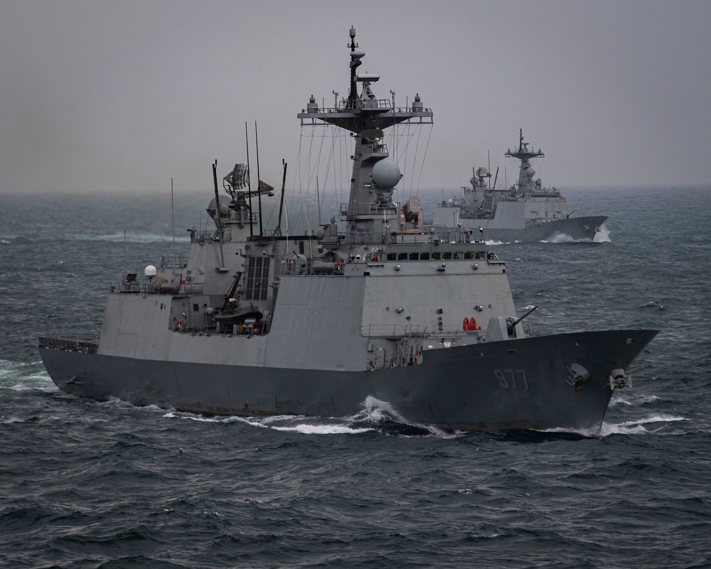 230404-N-MH015-1116 EAST CHINA SEA (April 4, 2023) The Republic of Korea (ROK) Chungmugong Yi Sun-Shin-class destroyers ROKS Dae Jo young (DDH 977) and ROKS Choi Young (DDH 981) steam in formation with the aircraft carrier USS Nimitz (CVN 68). The Nimitz Carrier Strike Group is conducting a trilateral maritime exercise with the ROK Navy and Japan Maritime Self-Defense Force in the U.S. 7th Fleet area of operations. 7th Fleet is the U.S. Navy's largest forward-deployed numbered fleet, and routinely interacts and operates with allies and partners in preserving a free and open Indo-Pacific region. (U.S. Navy photo by Mass Communication Specialist 2nd Class Joseph Calabrese)