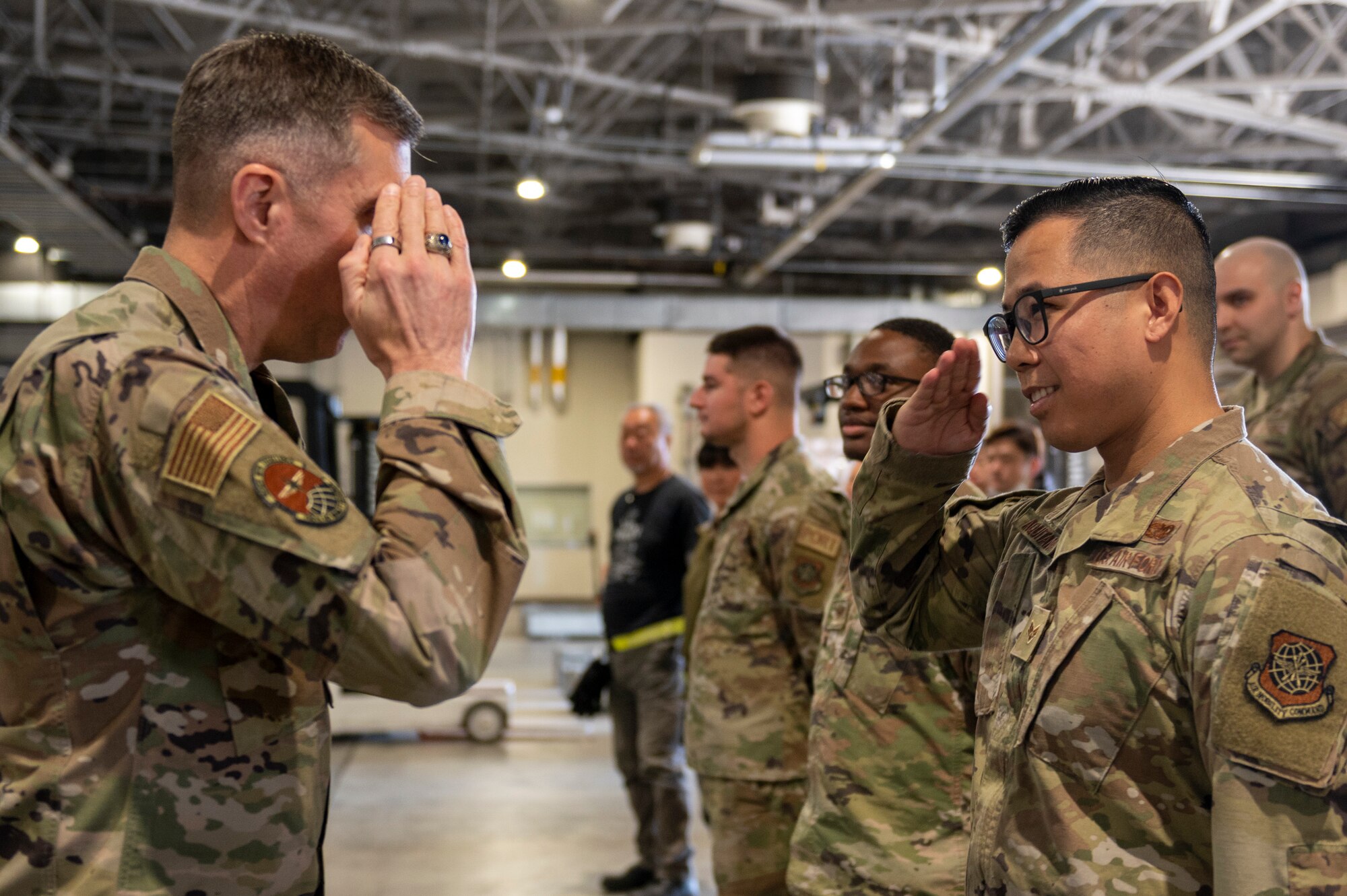 A general salutes another soldier standing in formation.