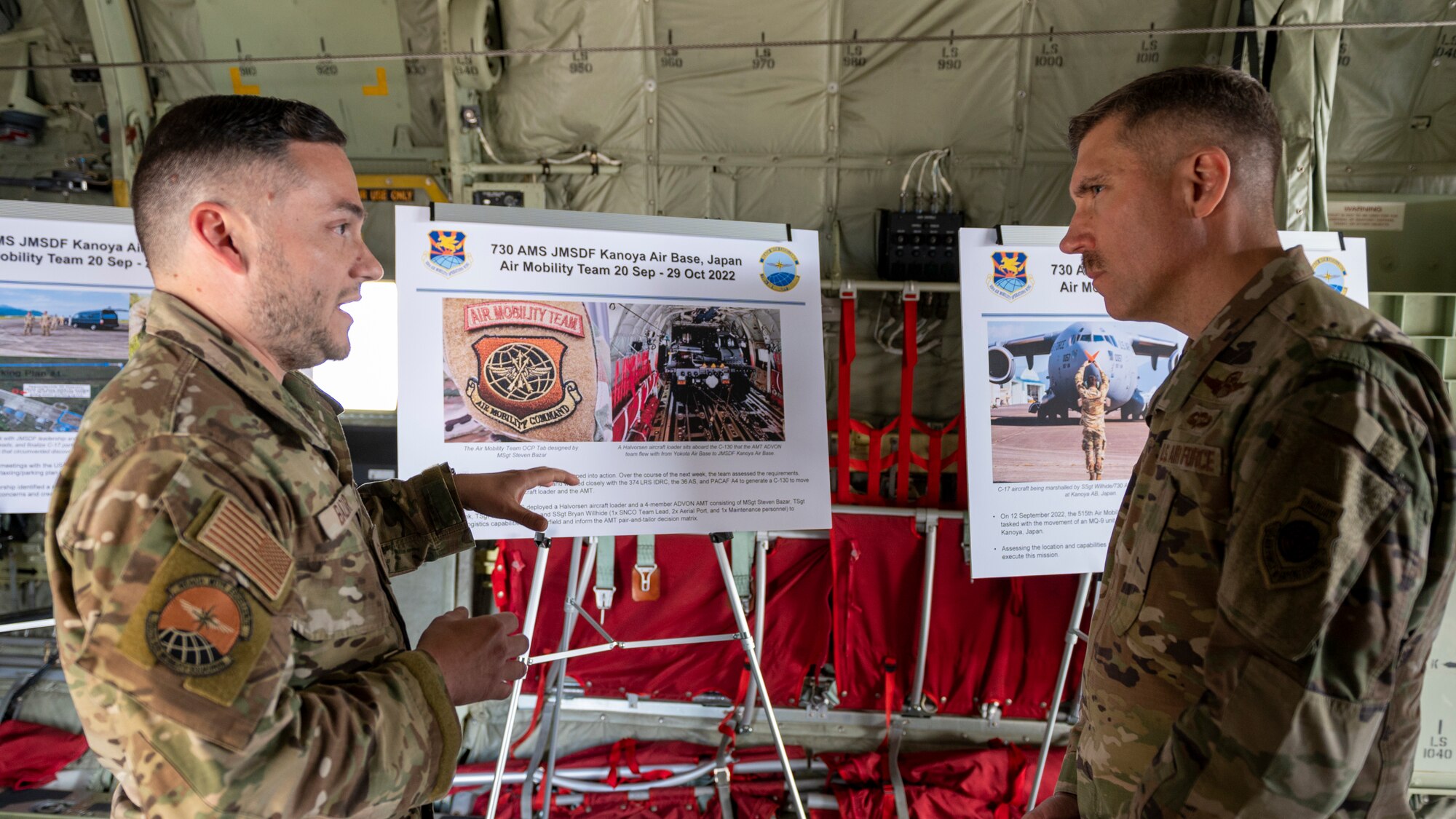 A short man gives a presentation to a taller general