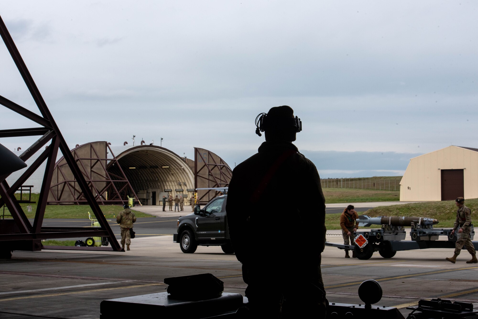 Airmen load munitions onto an aircraft.