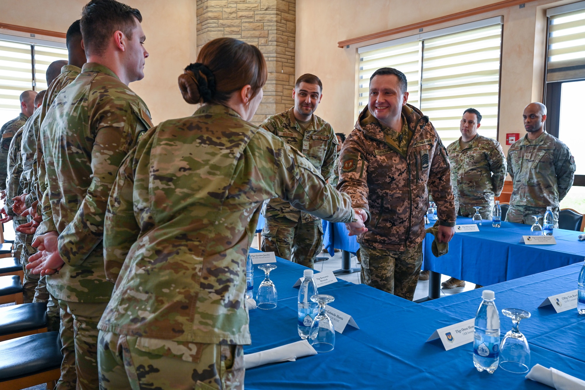 Chief Master Sgt. of the Air Force of the Armed Forces of Ukraine Kostiantyn Stanislavchuk, right, engages with Airmen during a luncheon