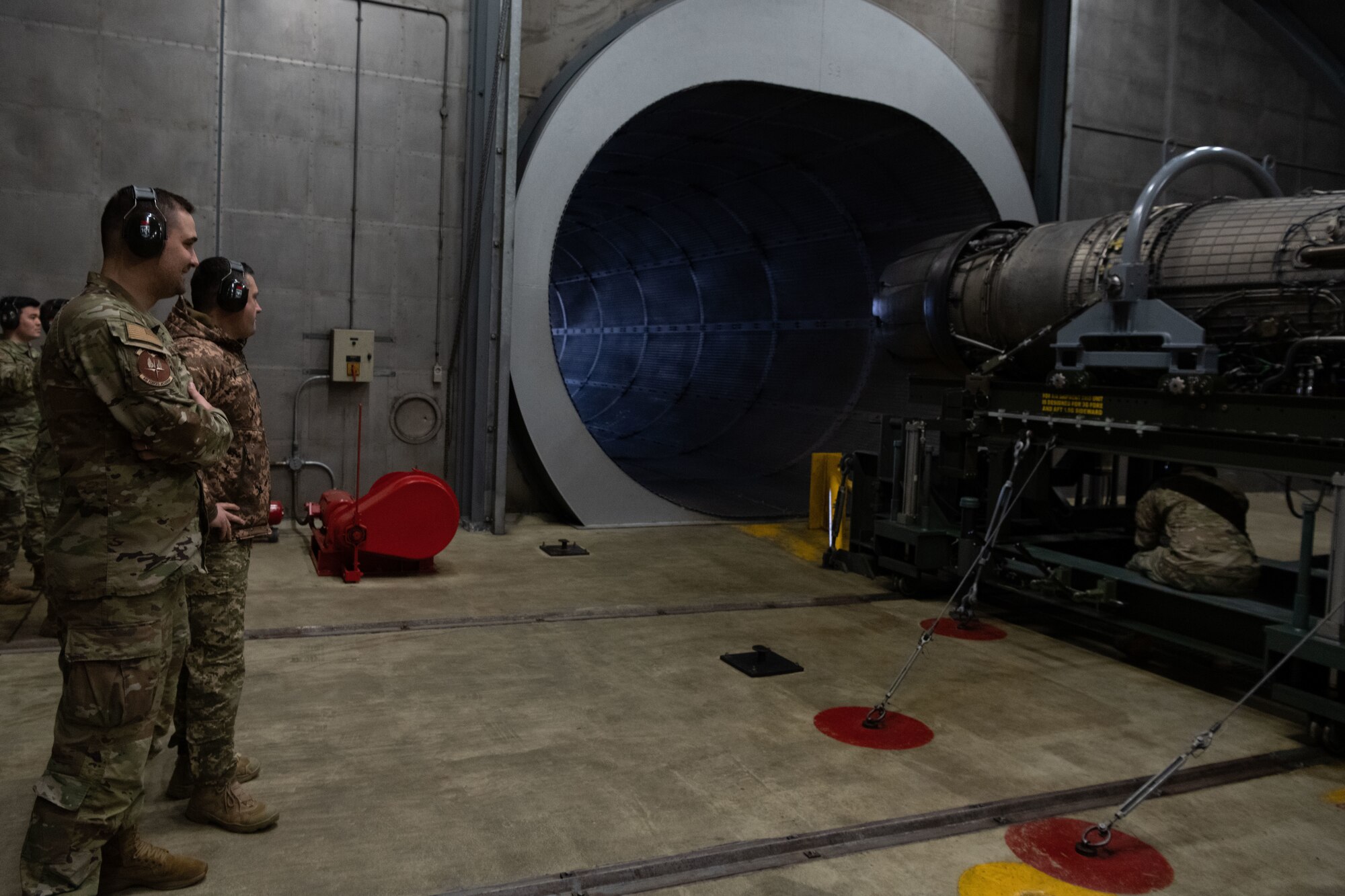 Chief Master Sgt. of the Air Force of the Armed Forces of Ukraine Kostiantyn Stanislavchuk watches an F-16 engine blast into an engine test cell.