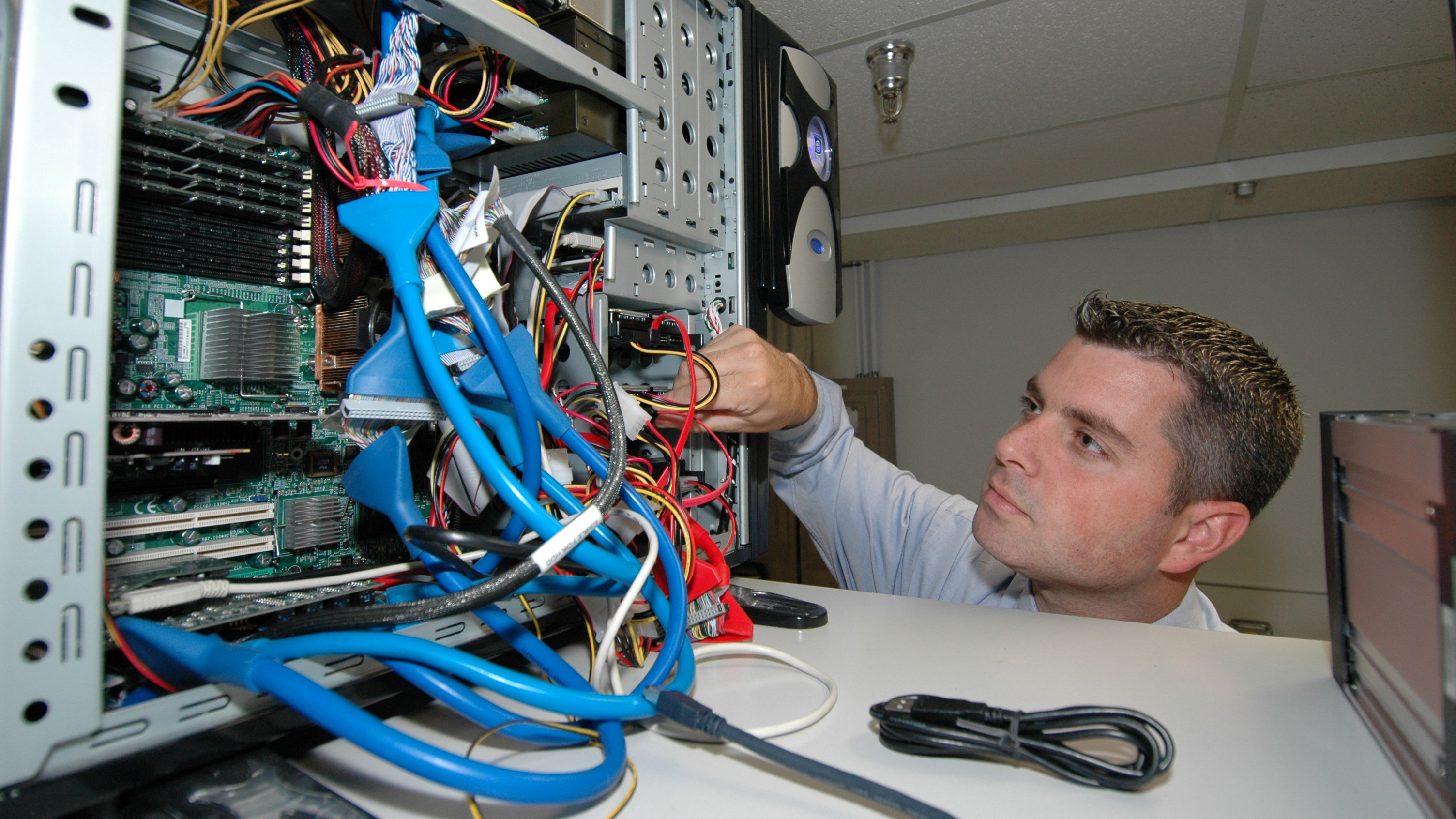 CID Forensic Agent inspects computer hardware