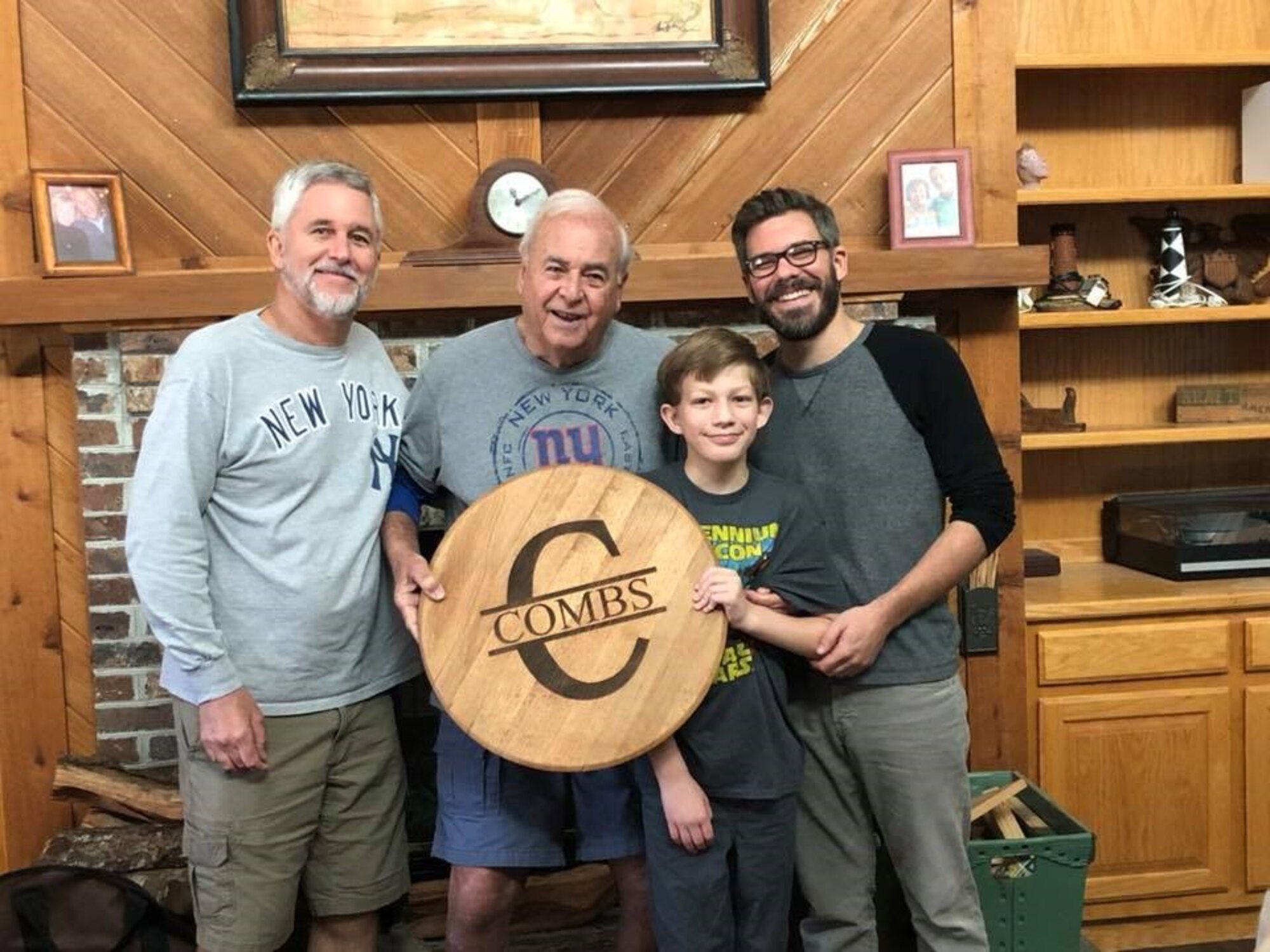 Four generations of the Combs family pose for a photo. Danny Combs, far right, is an Air Force Reserve senior airman who founded TACT, Teaching the Autism Community Trades, in 2016.