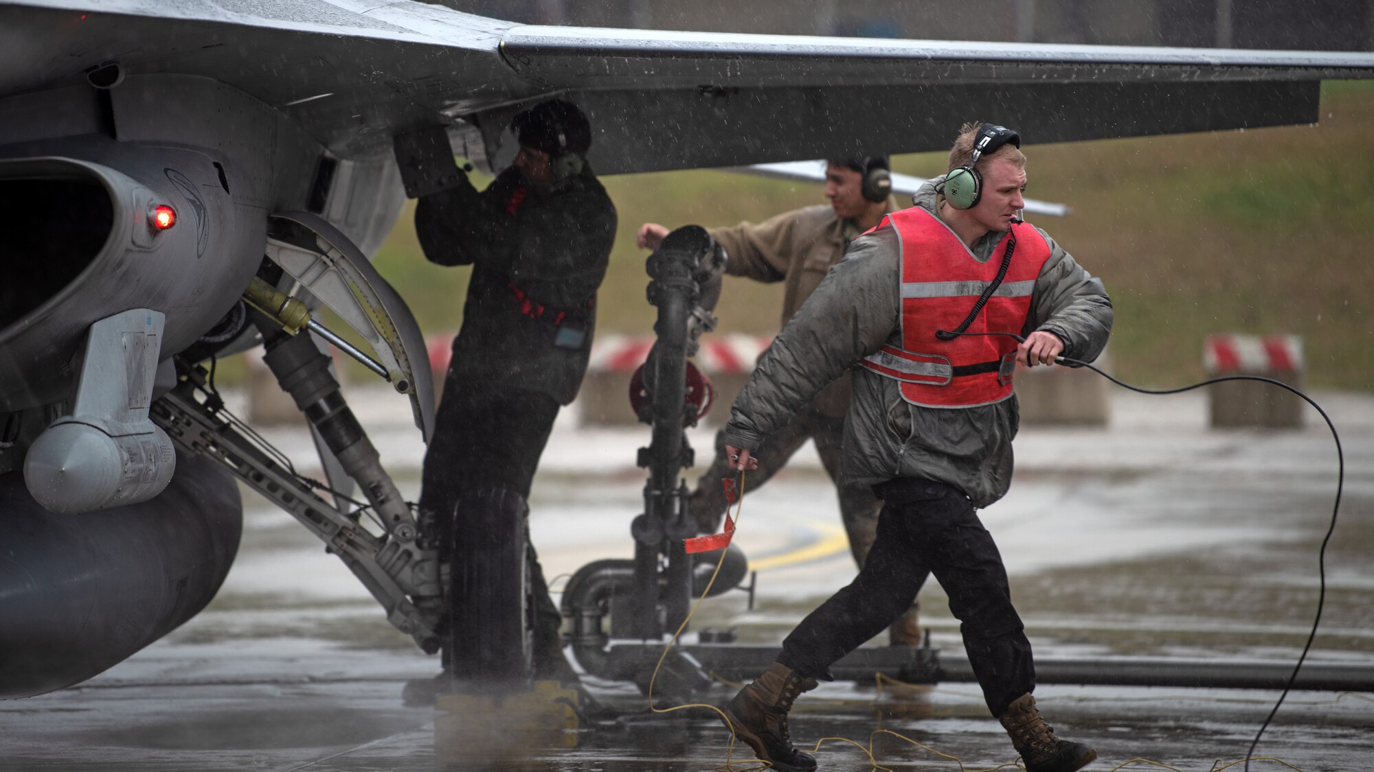 People conduct hot-pit refuel.