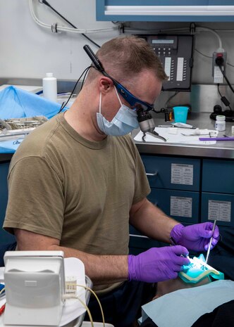 230329-N-OX847-1006 TYRRHENIAN SEA (March 29, 2023) Lt. Bryan Gordon, assigned to the Nimitz-class aircraft carrier USS George H.W. Bush (CVN 77), performs dental work on a Sailor, March 29, 2023. The George H.W. Bush Carrier Strike Group is on a scheduled deployment in the U.S. Naval Forces Europe area of operations, employed by U.S. Sixth Fleet to defend U.S., allied and partner interests.(U.S. Navy photo by Mass Communication Specialist Seaman Christopher Spaulding)