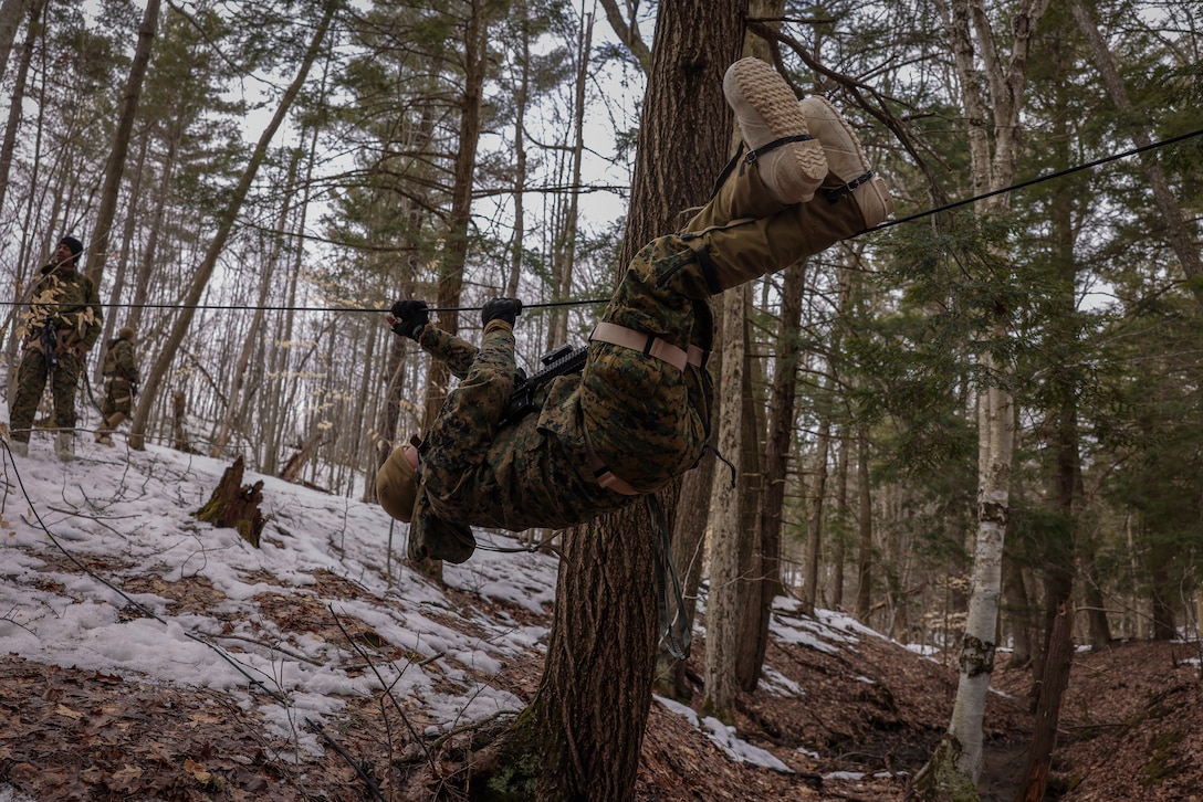 A U.S. Marine with 1st Battalion, 10th Marine Regiment, 2d Marine Division participates in a rope course during exercise Rolling Thunder on Fort Drum, New York, March 24, 2023.