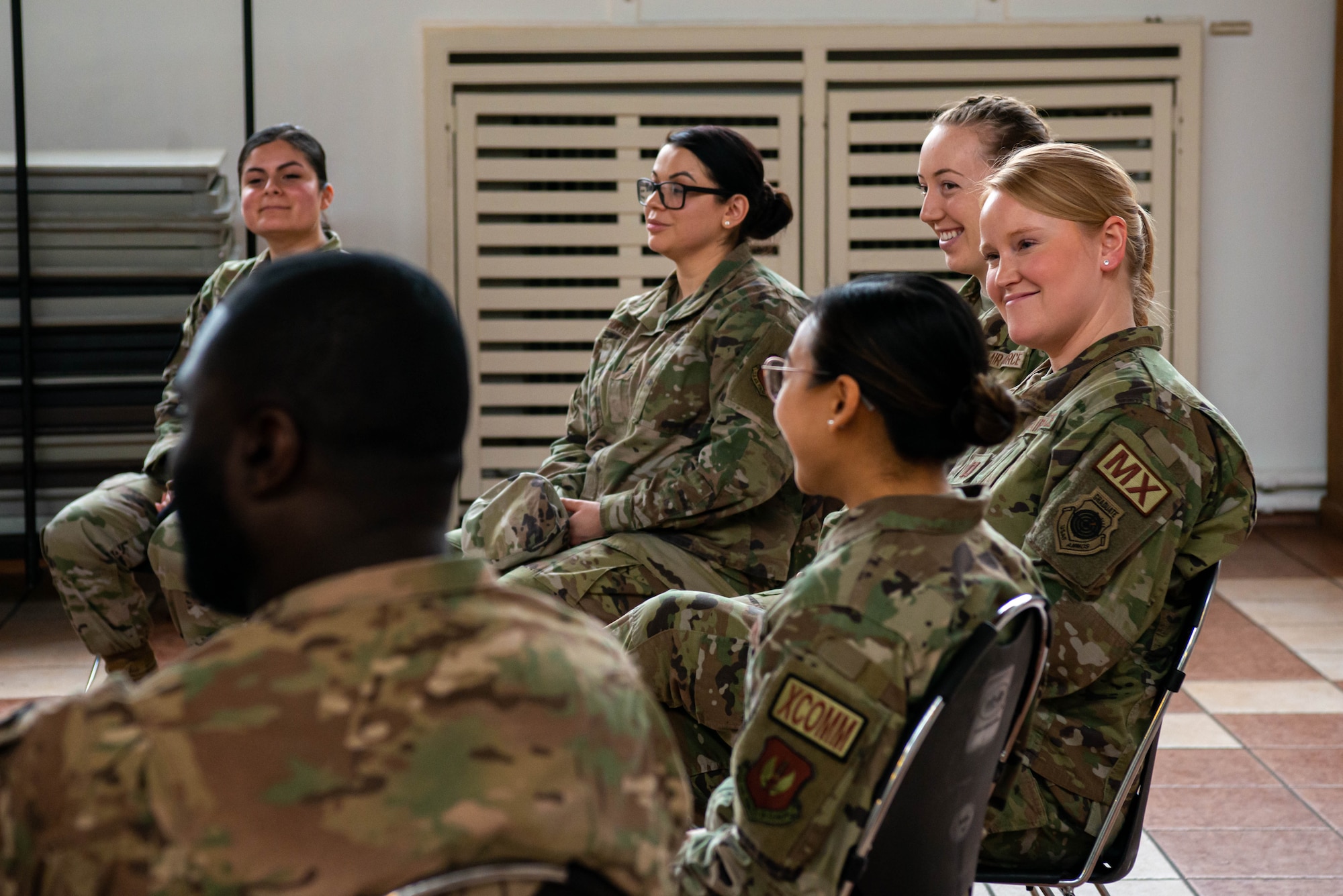 Airman sit and talk during a panel.