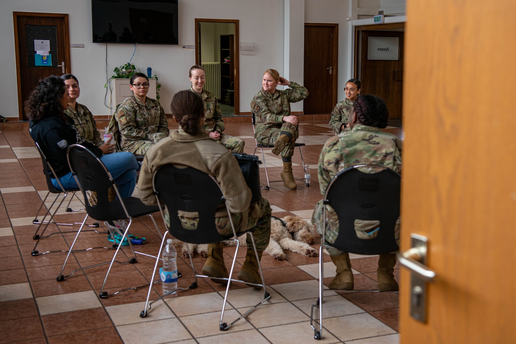 Airman sit and talk in a panel.