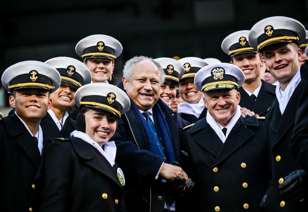 Secretary of the Navy Carlos Del Toro and Chief of Naval Operations Adm. Michael Gilday pose with midshipmen at the 123rd Army Navy Game at Lincoln Financial Field in Philadelphia, Pennsylvania on Dec. 10, 2022.