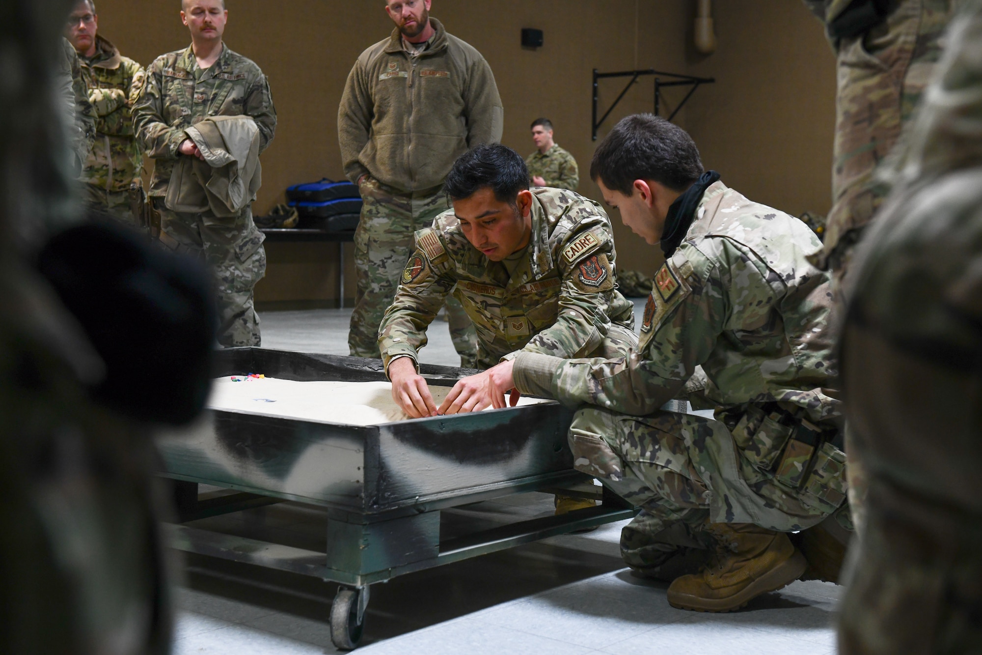 Staff Sgt. Ryan Cisneros, an Integrated Defense Leadership Course cadre member assigned to the 310th Security Forces Squadron, Schriever Space Force Base, Colorado, teaches a hands-on land navigation course on March 14, 2023, at Youngstown Air Reserve Station, Ohio.