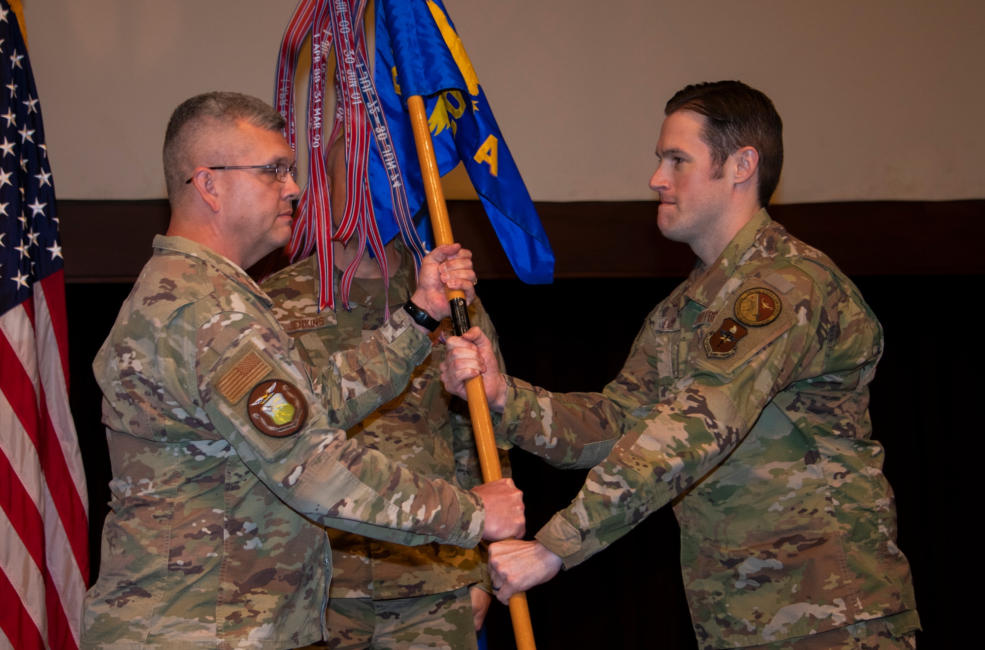 Col. Anthony D. Babcock, commander of the Thomas N. Barnes Center for Enlisted Education, passed the Air Force Senior Noncommissioned Officer Academy guidon to Chief Master Sgt. Alex. J. Eudy during an assumption of leadership ceremony at the academy on Maxwell Air Force Base–Gunter Annex, Ala., March 31, 2023. (U.S. Air Force photo/Brian Ferguson)
